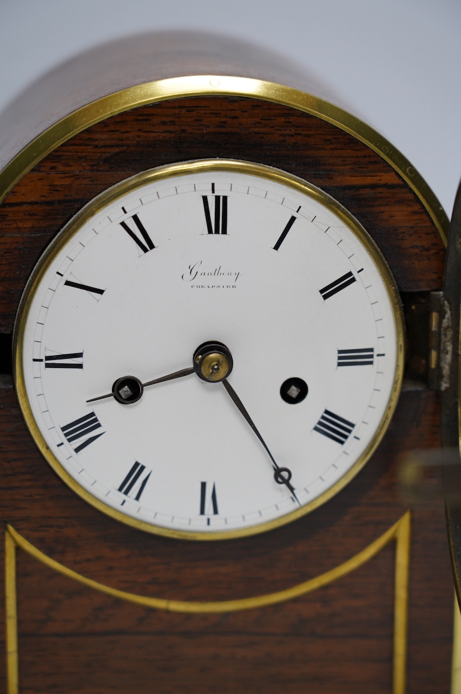 A rosewood brass inlaid eight day mantel clock with enamel dial inscribed Gantheny, Cheapside, with pendulum, no key, 22cm high. Condition - fair to good, not tested as working